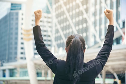 Preview: Victory of Success Businesswoman Holding hands as a winner.