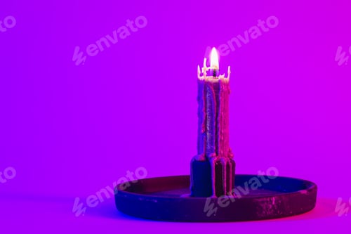 Preview: Texture vintage candle on a pink background with neon lighting, copy space.