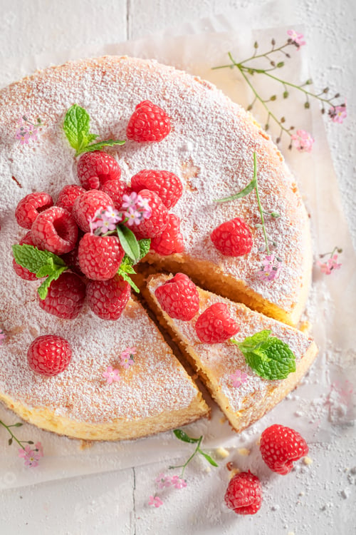 Preview: Homemade cheesecake with berry fruit and powdered sugar.