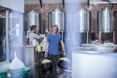 Preview: Man in microbrewery carrying beer kegs