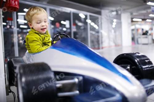 Preview: Little boy driving a racing car