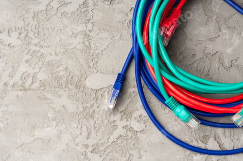 Preview: Colored network cable patch-cord on gray textured background