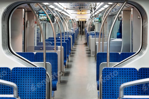 Preview: Interior of a Modern Commuter Train with Blue Seats and Silver Handrails for Public Transport