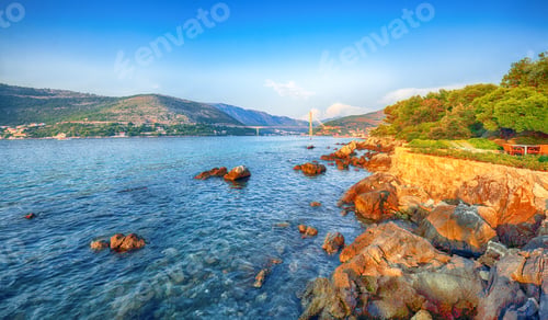 Preview: Panorama of impressive Franjo Tudjman bridge at sunset and rocky shore of Dubrovnik.