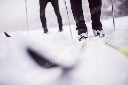 Preview: An unrecognizable couple cross-country skiing in winter.