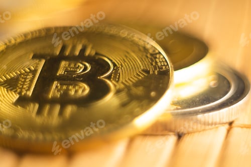 Preview: High angle shot of golden coins with bitcoin symbol on a wooden surface
