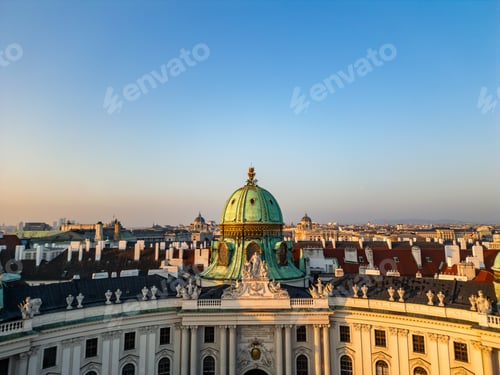 Preview: Vienna cityscape with Hofburg Palace dome during sunrise aerial drone view