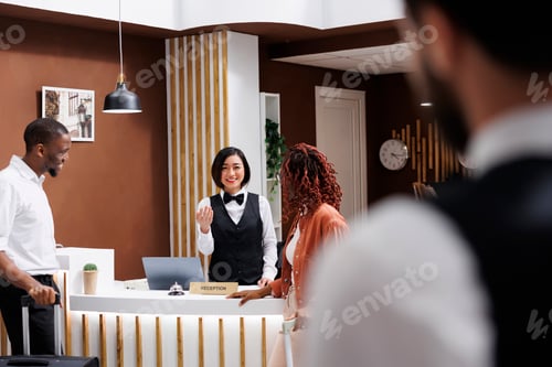 Preview: Receptionist talking to hotel guests