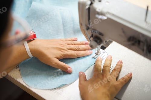 Preview: Dressmaker sews a dress on a sewing machine