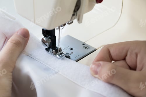Preview: woman sews on the sewing machine