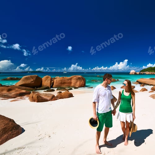 Preview: Couple In Green On A Tropical Beach At Seychelles