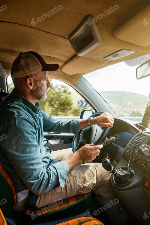 Preview: Man driving van on rural road.