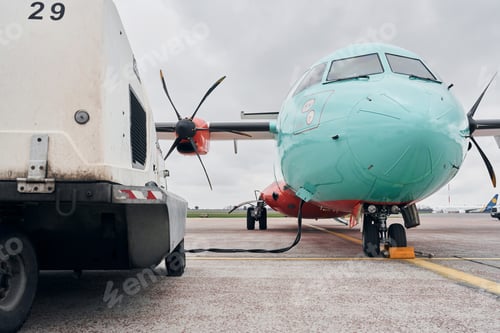 Preview: Turboprop aircraft parked on the runway at daytime