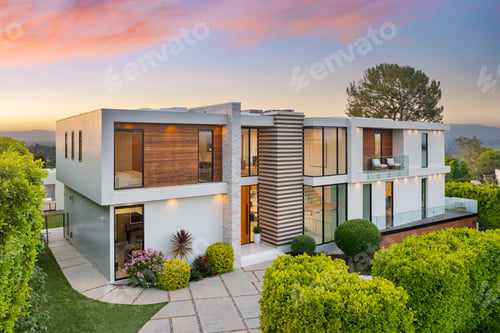 Preview: Contemporary two-level home on hillside with shrubs and trees