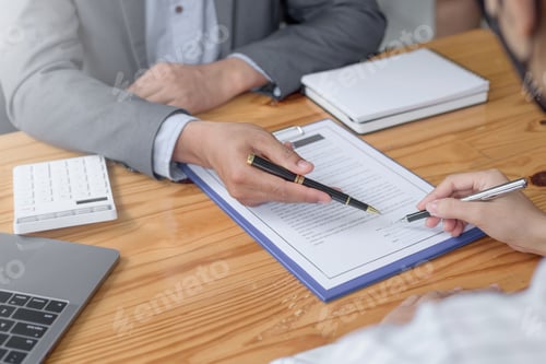 Preview: Businessman and woman discussing contract in office. Contracting and signing business investments