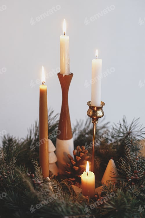 Preview: Stylish candles burning in christmas wreath on wooden table. Christmas advent. Atmospheric time