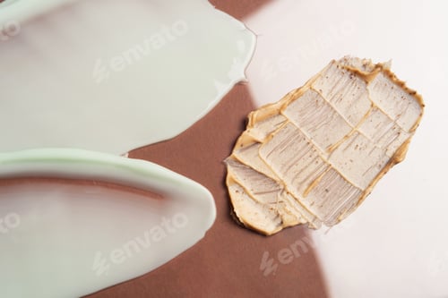 Preview: Skin scrub smear on broun background. Texture of skin care cosmetic product