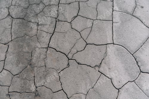 Preview: Grey cracked earth ground from drought disaster cause from weather change.