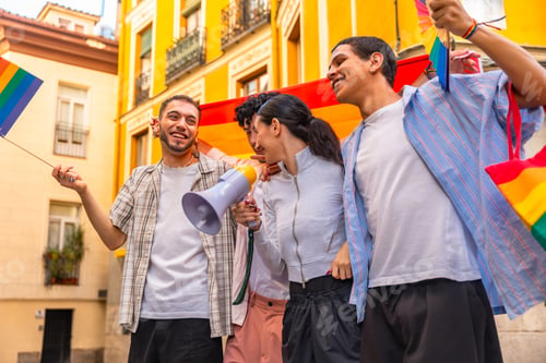 Preview: Diverse friends celebrating pride with rainbow flags and megaphone