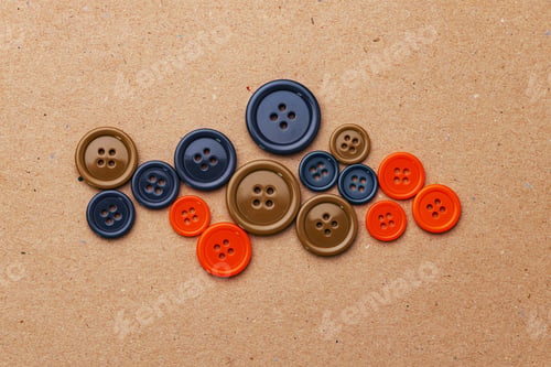 Preview: Set of multicolored buttons on beige background