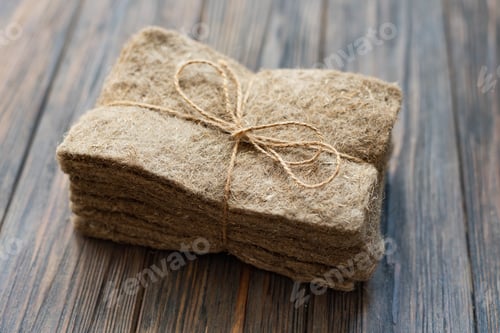 Preview: Packs of linen mats on white wooden background.