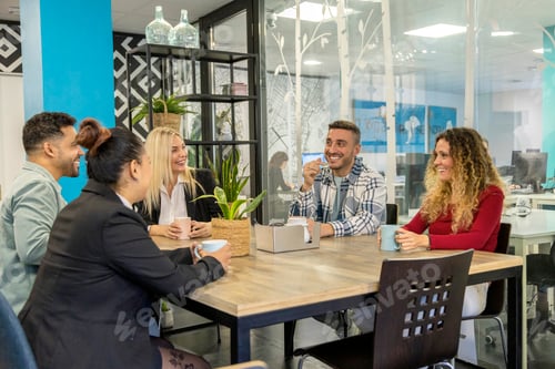 Preview: Office colleagues gather for coffee in a casual meeting