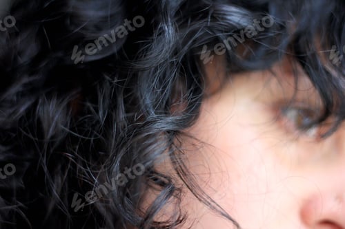 Preview: Curly hair of brunette woman, close up