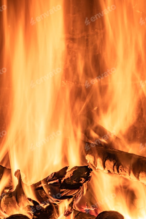 Preview: Vertical closeup shot of the flame of burning pieces of wood