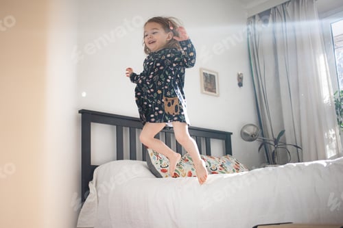 Preview: Toddler girl jumping from the bed