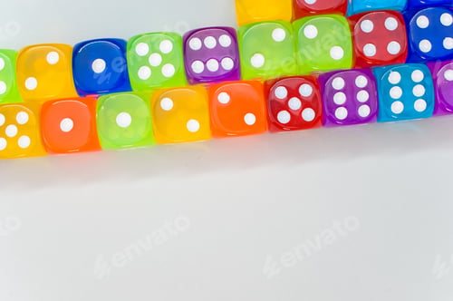 Preview: Top view of a group of colorful transparent dice on white background for a copy space