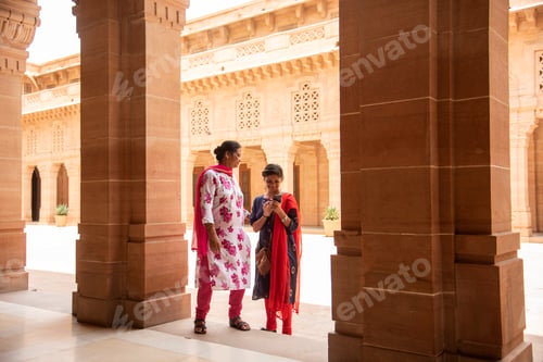Preview: Indian woman standing between arches and Pillars.