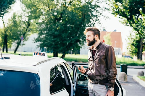 Preview: Young bearded man taking taxi