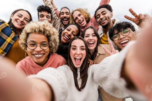 Preview: Multiracial friends taking big group selfie shot smiling at camera