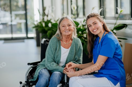 Preview: Young woman doctor taking care of senior woman at wheelchair.