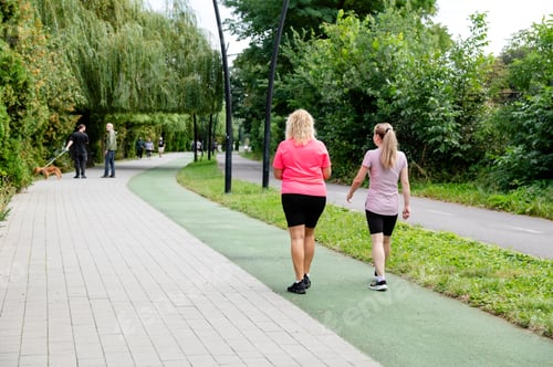Preview: Women enjoying time outdoors while walking in a park, everyday moments
