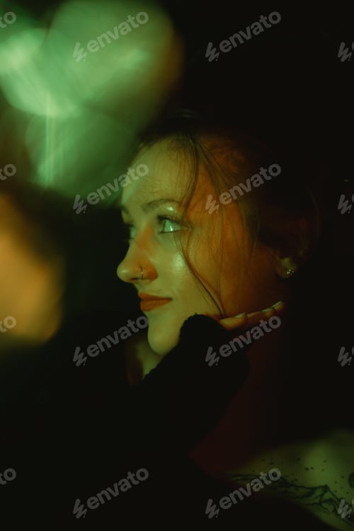 Preview: woman looking up to her right with dark background, looking over shoulder