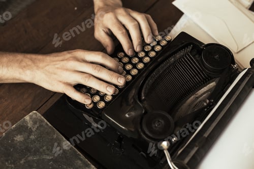 Preview: Young man's hands typing on an antique vintage typewriter