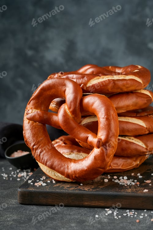 Preview: Oktoberfest concept card. Traditional Bavarian pretzels with beer bottle mug on old dark black rusti