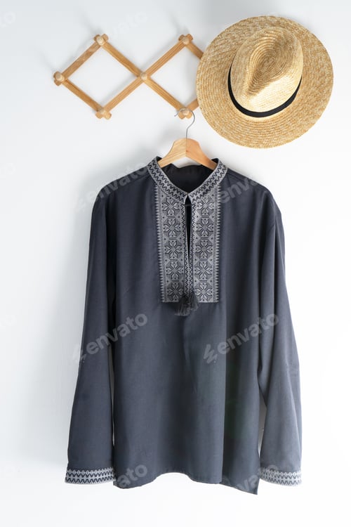 Preview: Ukrainian clothes embroidered man shirt. Blue gray and black threads background. Vyshyvanka is a