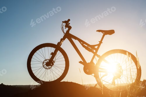 Preview: Silhouette Mountain biking on the rock at sky sunset