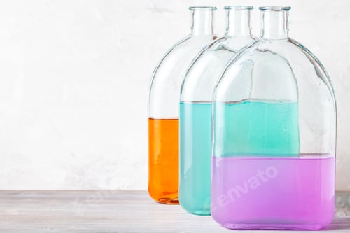 Preview: Colorful Liquids in Glass Bottles on Table