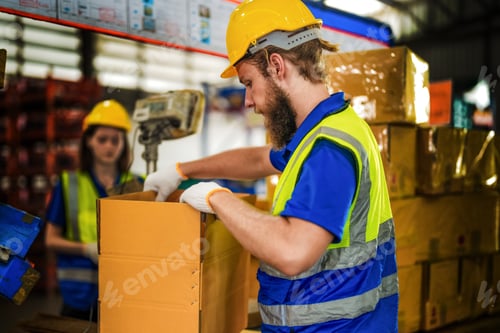 Preview: Warehouse worker folding paper box for packing the items