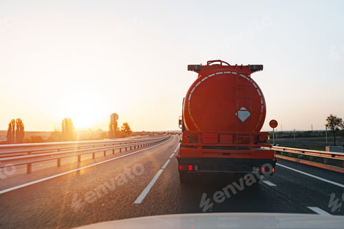 Preview: Truck driving on highway road at sunrise