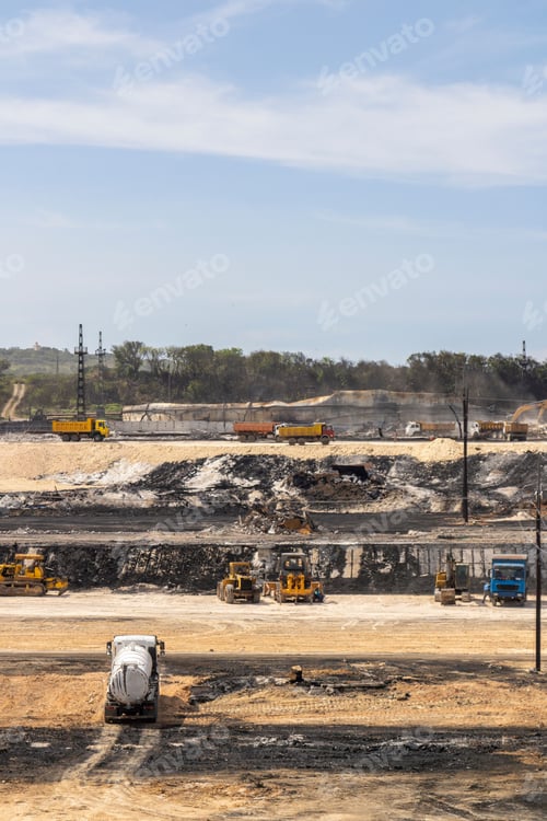 Preview: Vertical shot of construction trucks working at the site
