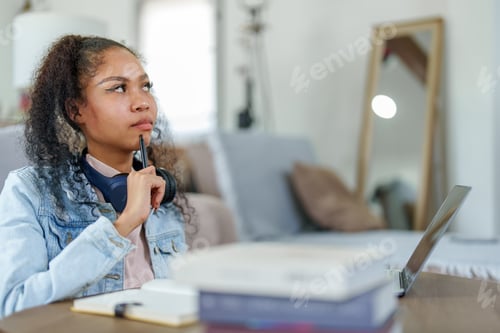 Preview: African American using computers and notebooks to study online