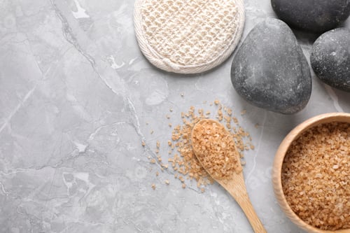 Preview: Flat lay composition with brown sea salt on marble background, space for text. Spa treatment