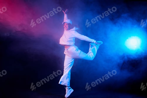 Preview: a girl in light clothes dances on a neon background in smoke, modern dance
