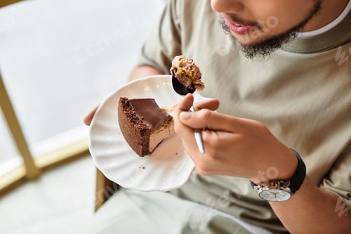 Preview: Young man enjoying cake in a vibrant cafe