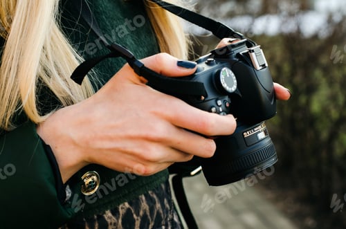 Woman Holding a Camera with Blonde Hair