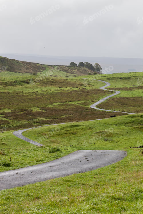 Preview: A winding road across open moorland countryside.